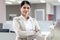 Portrait of happy smiling Asian woman officer worker standing with arms crossed, confident attractive female beautiful