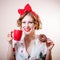 Portrait of happy smiling blond girl beautiful young lady having fun holding red cup of beverage & donut