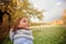 Portrait of happy smiling cute little girl child outdoors in sautumn day