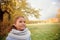 Portrait of happy smiling cute little girl child outdoors in sautumn day