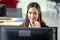 Portrait of happy smiling female customer support phone operator at workplace. Professional operator concept