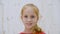 Portrait happy smiling girl in light studio background. Face cute girl with toothy smile looking to camera. Positive