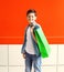 Portrait happy smiling little boy teenager with shopping bag in city