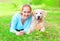 Portrait of happy smiling owner woman and Golden Retriever dog is lying on grass summer