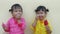 Portrait of a happy smiling sibling child girls and enjoy eating ice cream isolated on white background.