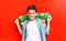 Portrait happy smiling teenager boy wearing a checkered shirtwith skateboard in city