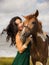 Portrait of happy smiling woman and brown horse. Asian woman hugging horse. Romantic concept. Human and animals relationship.