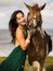 Portrait of happy smiling woman and brown horse. Asian woman hugging horse. Romantic concept. Human and animals relationship.