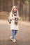 Portrait of a happy smiling woman walking in the forest a spring day outside. Portrait of a beautiful blonde woman outdoor in a