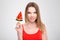 Portrait of happy smiling woman with watermelon shaped lollipop