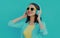 Portrait happy smiling young woman with wireless headphones listening to music on a blue background