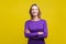 Portrait of happy successful businesswoman looking at camera with toothy smile. indoor studio shot isolated on yellow background