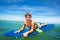 Portrait of happy surfing boy lay on surfboard