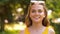 Portrait of happy teenage girl in summer park