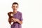 Portrait of happy teenaged disabled boy with cerebral palsy smiling at camera and holding his teddy bear toy, posing