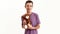 Portrait of happy teenaged disabled boy with cerebral palsy smiling at camera and holding his teddy bear toy, posing