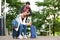 Portrait of happy tourist couple outside with luggage in city