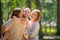 Portrait of a happy traditional family on walk in a summer park