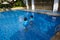 Portrait of happy twins  in swimming pool