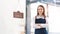 Portrait of a happy waitress standing at restaurant entrance. Portrait of mature business womanattend new customers in