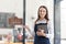 Portrait of a happy waitress standing at restaurant entrance. Portrait of mature business womanattend new customers in