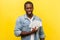 Portrait of happy wealthy man holding dollar bills, enjoying lots of money. isolated on yellow background