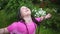 Portrait of happy wet child in rain in garden in hot summer. kids fun outroors on vacation. rainy weather.