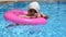 Portrait of happy white Caucasian child baby girl toddler in swimming pool outdoor. Preschool boy training to float with