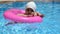 Portrait of happy white Caucasian child baby girl toddler in swimming pool outdoor. Preschool boy training to float with