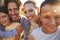 Portrait of happy white family embracing outdoors, close up