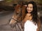 Portrait of happy woman and brown horse. Asian woman hugging horse. Romantic concept. Love to animals. Nature concept. Bali
