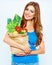 Portrait of happy woman with green vegan food in paper bag.