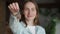 Portrait of happy woman moving in showing keys to new apartment. Cute woman standing in her new house showing the keys