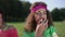 Portrait of happy woman peeling banana eating healthful exotic fruit in slow motion looking at camera. Young beautiful