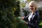 Portrait of happy woman pruning plants