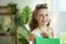 Portrait of happy woman shopper in blouse with shopping bags