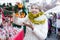 Portrait of happy woman in tinsel choosing Christmas decoration