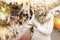 Portrait of happy woman in tinsel choosing Christmas decoration