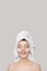 Portrait of a happy woman. Towel on the head. Perfect skin