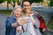 Portrait of happy women friends taking selfie outdoors with shopping bags