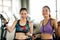 Portrait Of Happy Women Holding Jump Ropes In Gym