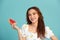 Portrait happy young Asian woman is holding slice of watermelon, funny and happiness concept