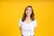 Portrait happy young asian woman laughing blink, wink eye joyful funny positive emotion in white t-shirt