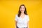 Portrait happy young asian woman laughing blink, wink eye joyful funny positive emotion in white t-shirt