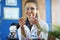 Portrait of happy young attractive smiling woman scientist in protective glasses in scientific chemical laboratory