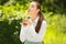 Portrait of happy young businesswoman kissing gold trophy cup in park