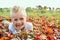 Portrait of Happy Young Child Laying in Fallen Autumn Leaves