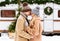 Portrait of happy young couple hugging and laughing outdoors in winter