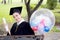 Portrait of happy young female graduates in academic dress and square academic cap