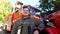 Portrait of happy young fireguard in uniform against background of a fire truck. Male firefighter looking into camera